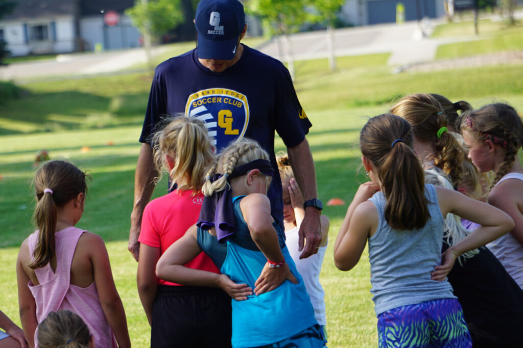 youth soccer players listening for instructions